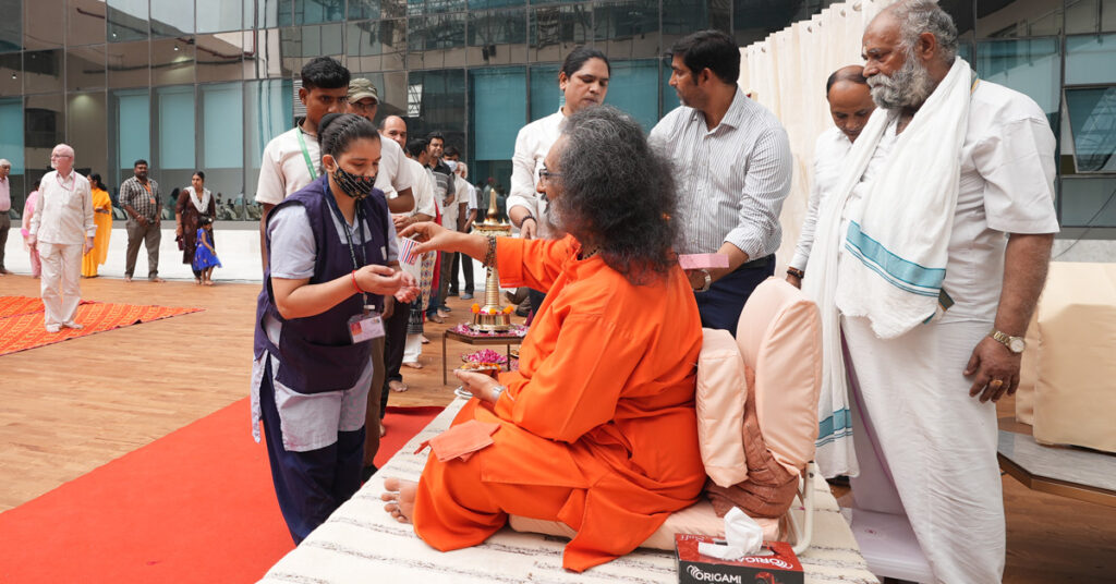 Swamiji distributing prasad