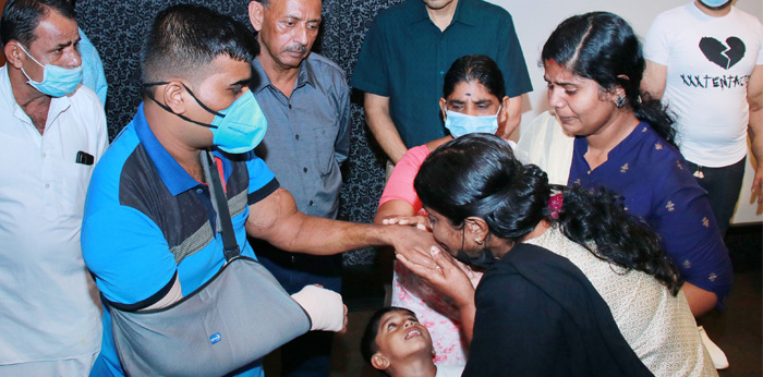 Amaresh stands with his family after the surgery where they kiss his hands