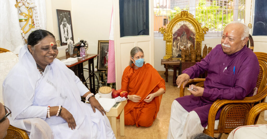 Amma sitting across from Dr. Bhagwat