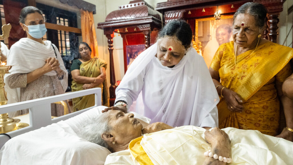 Amma caresses her mother's face