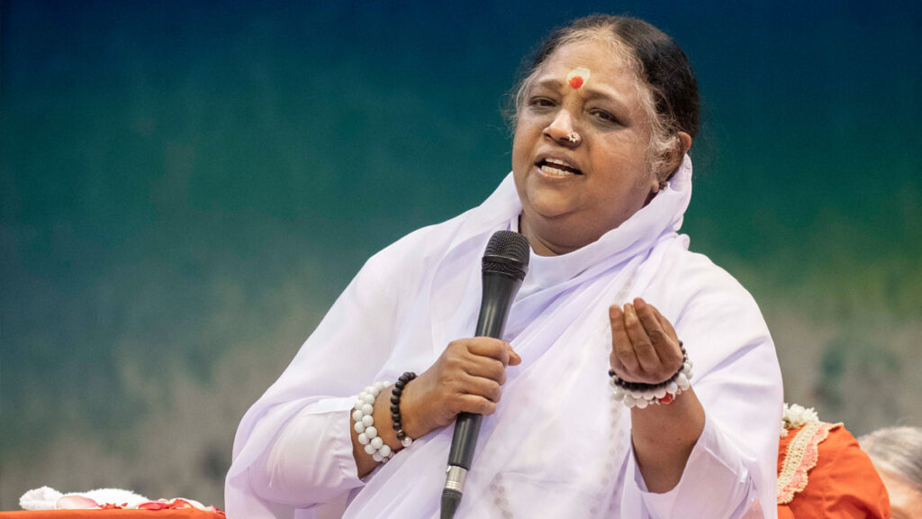 Amma speaking into a microphone