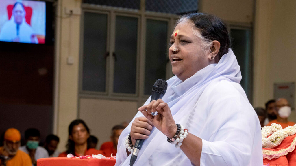 Amma speaking into a microphone