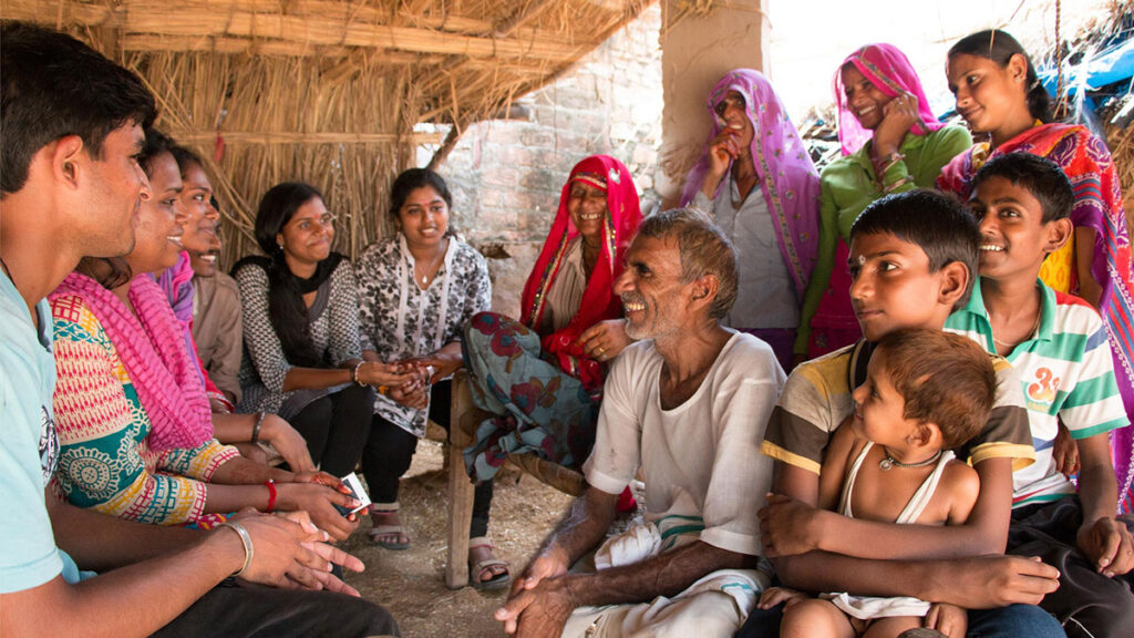 Villagers sit together and speak