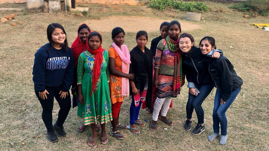 College students together with village children