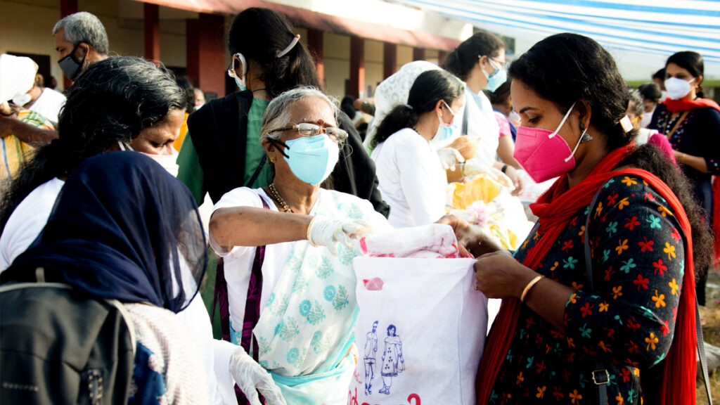 Women in masks distrubuting goods