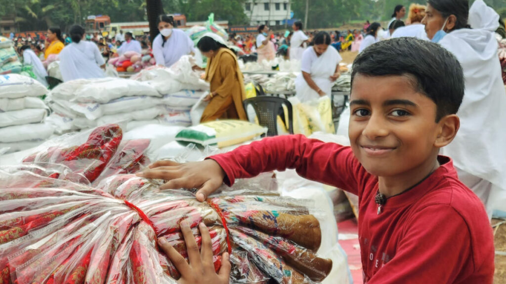 Young boy carresses packets of new saris