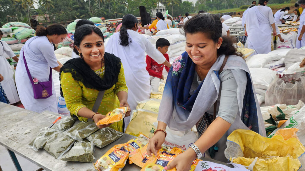 Women pass out packets of food supplies