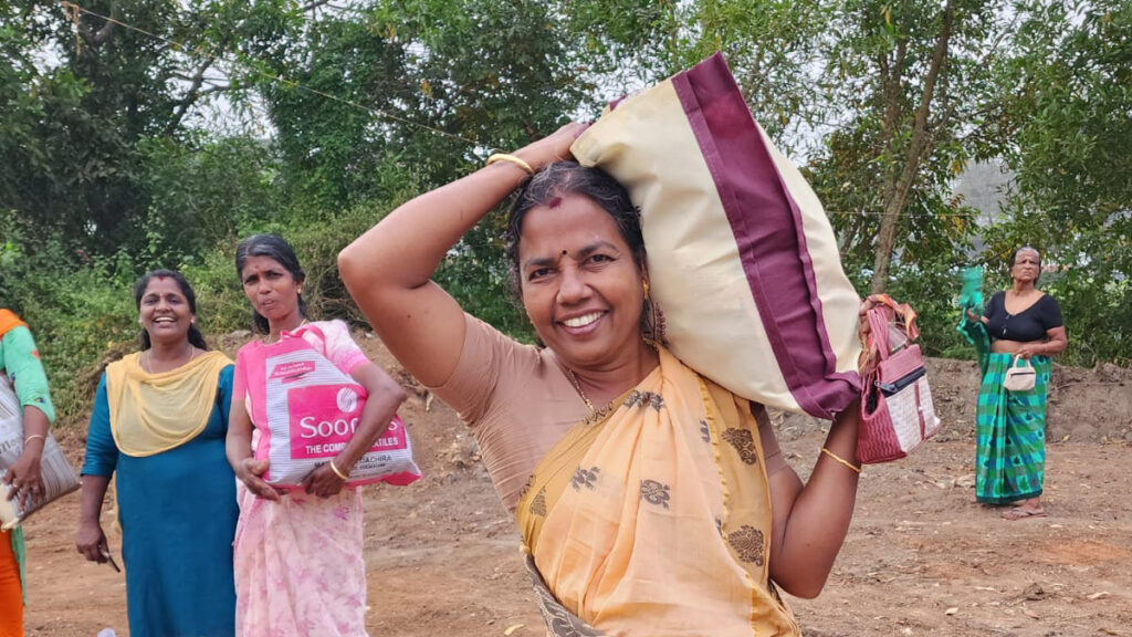 Women walk away smiling with their goods