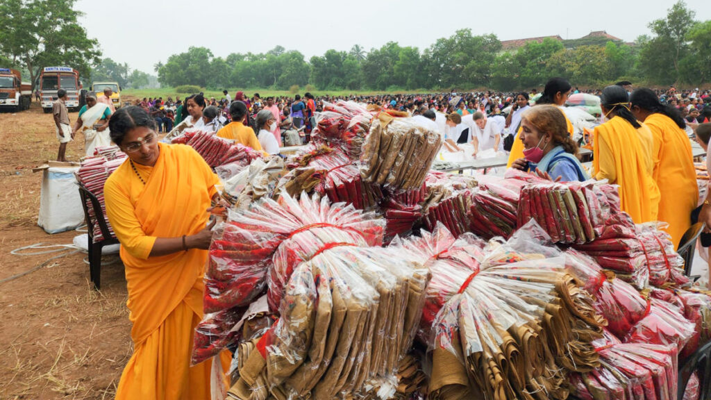 Huge piles of saris waiting to be given away