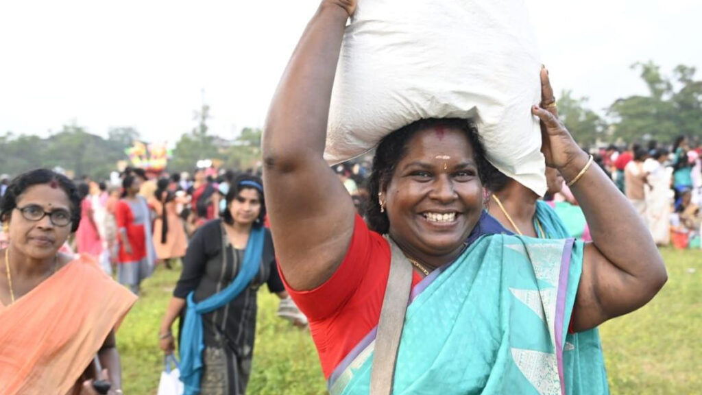 Woman carries bag on her head