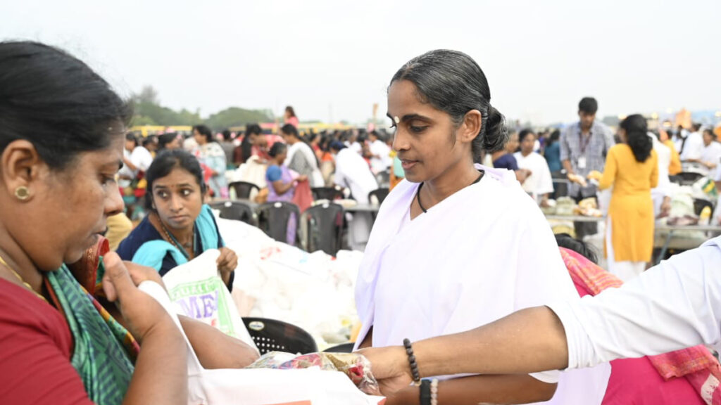 Amritapuri Ashram monastic distributes goods