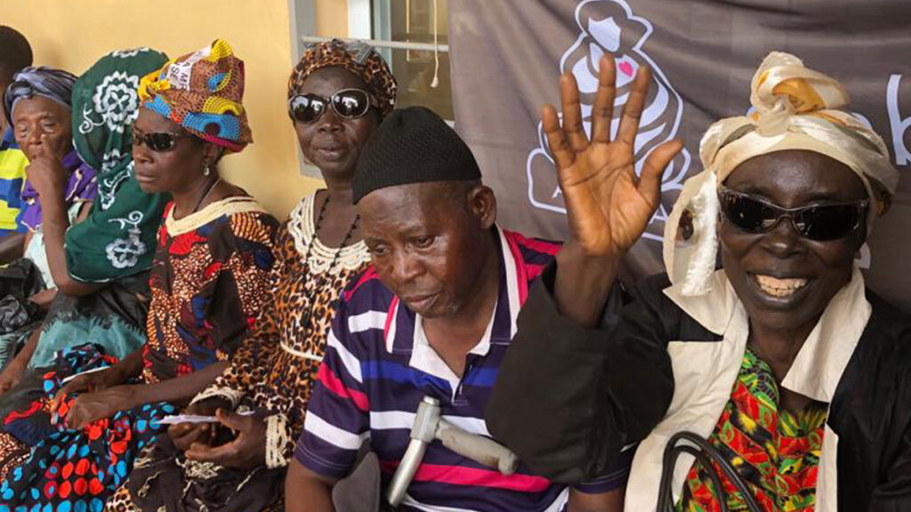 5 villagers at the hospital sitting down while waiting to be seen by doctors