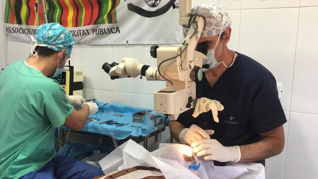 two doctors sitting down testing the medical equipment to be used.