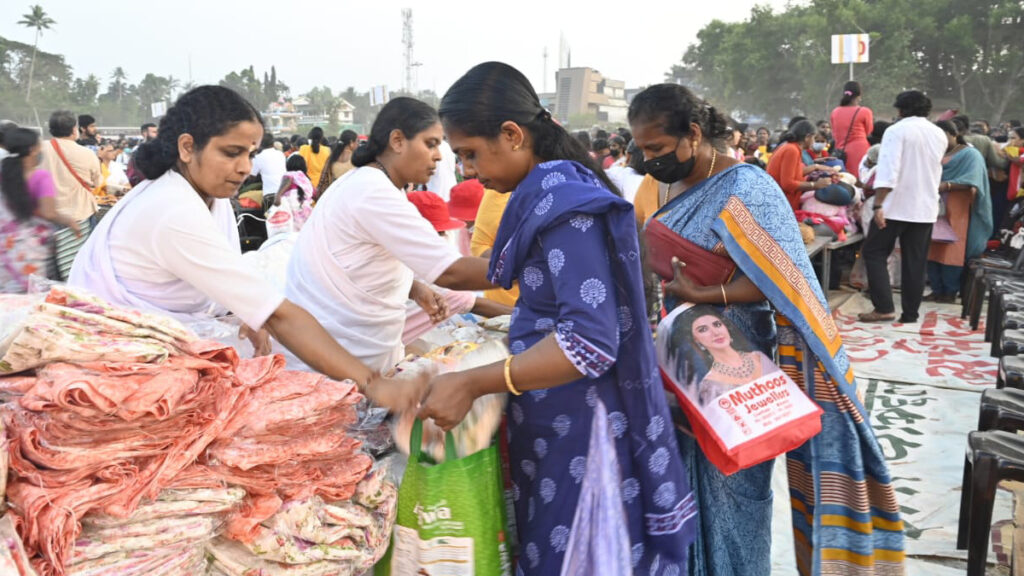 Recipients walk down a line to receive goods