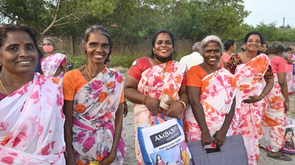 Women wear matching saris they received from last distribution