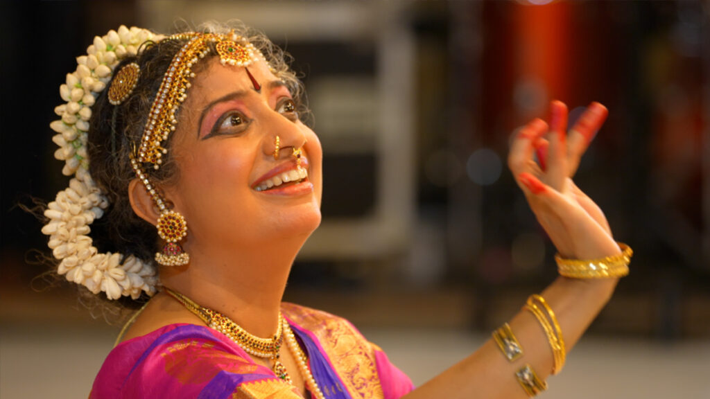 a woman in traditional indian dress during a dance performance