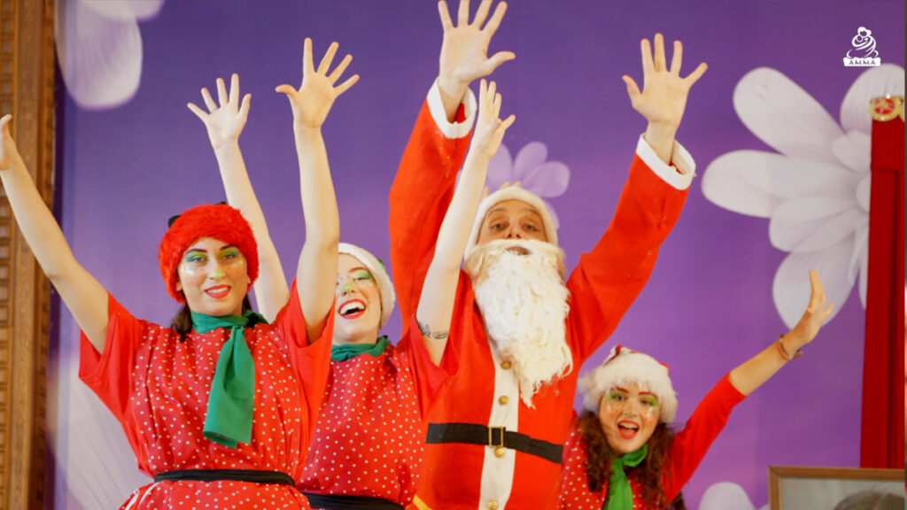 Santa Claus and people wearing Christmas outfits waiving hands in the air