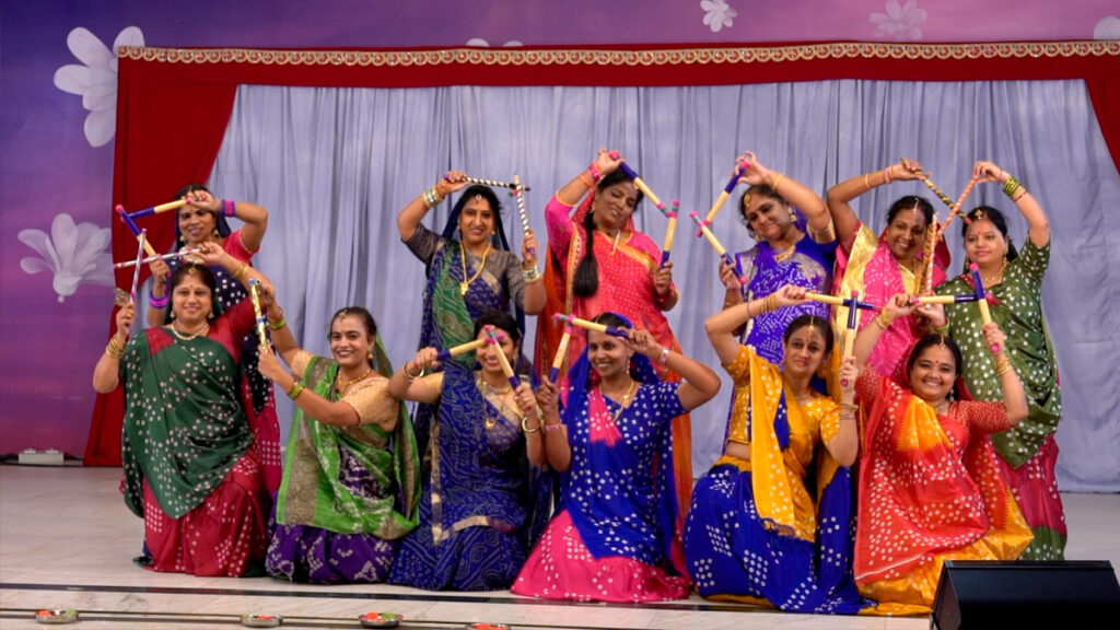 12 women posing at the end of their dance performance.  