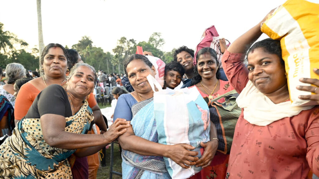 Groups of women hold their bags and smile