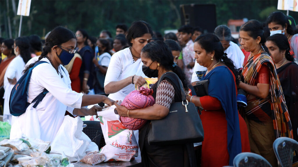 Amritapuri Ashram female monastics distribute food