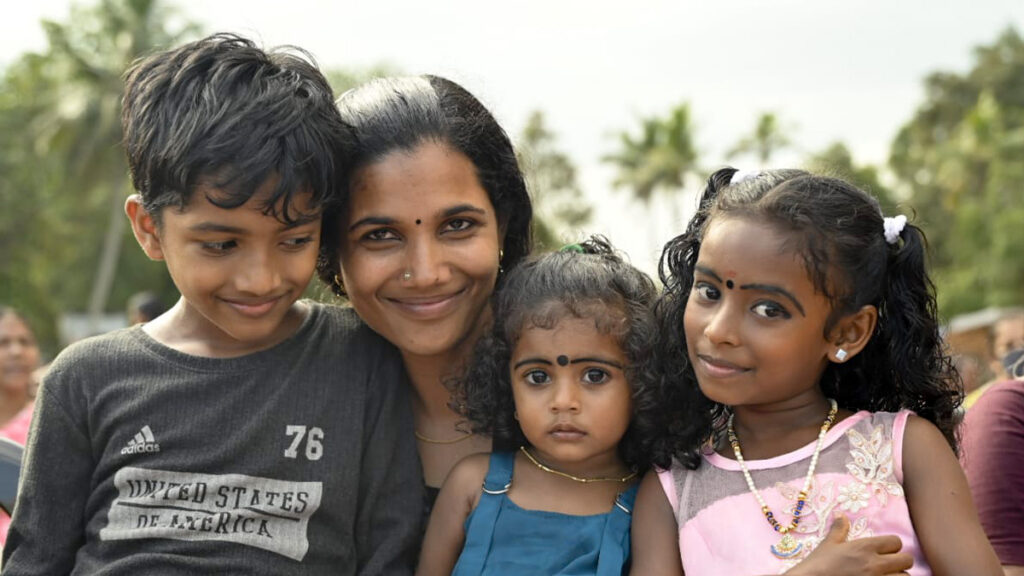 A family hug and smile into cameraa