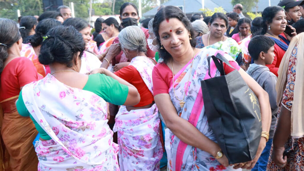 A crowd of women walk away with bags in their arms