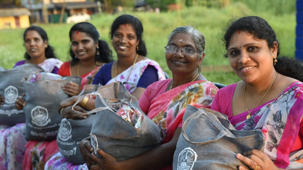 Women sit together with their bags of food