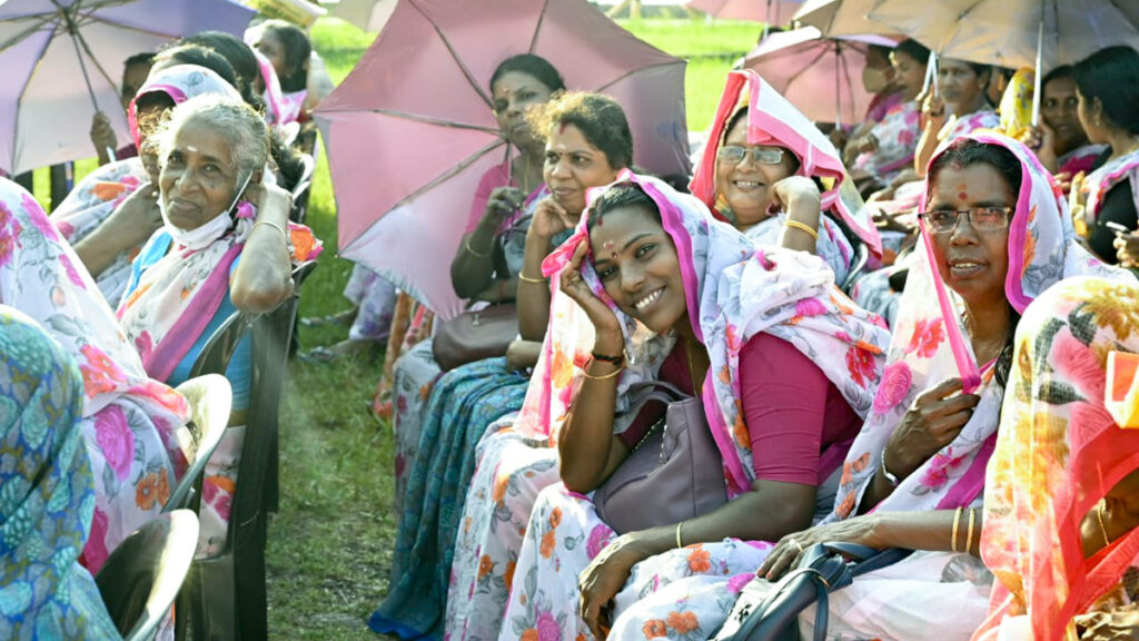 Women sit and smile in the sun