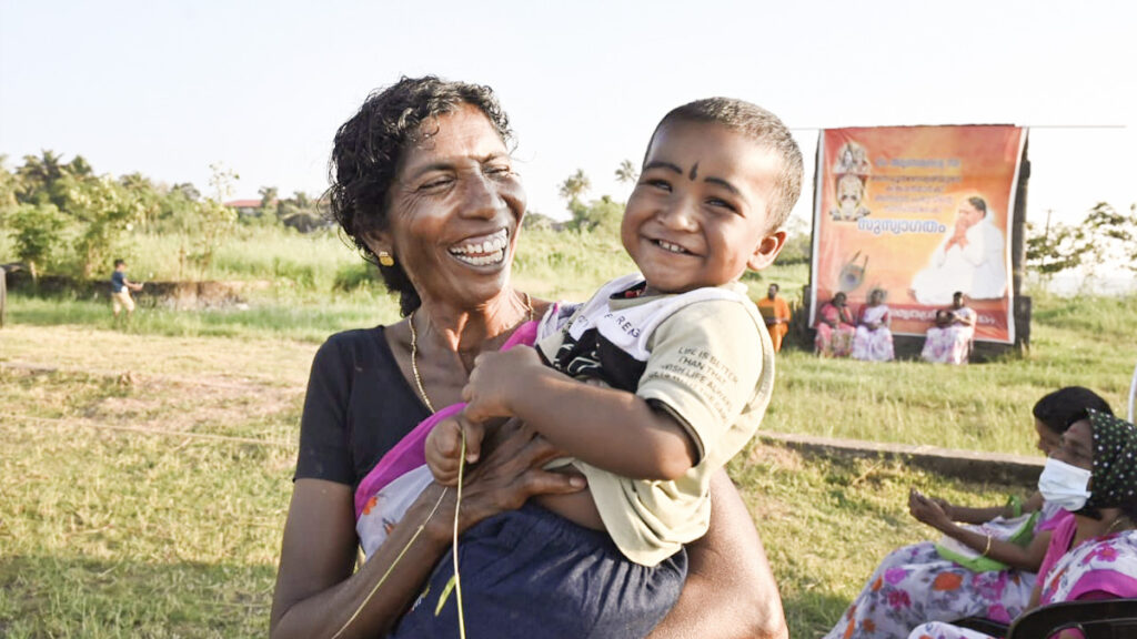 Woman and her baby laugh together