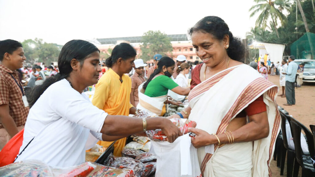 Amritapuri Ashram monastics pass out food items