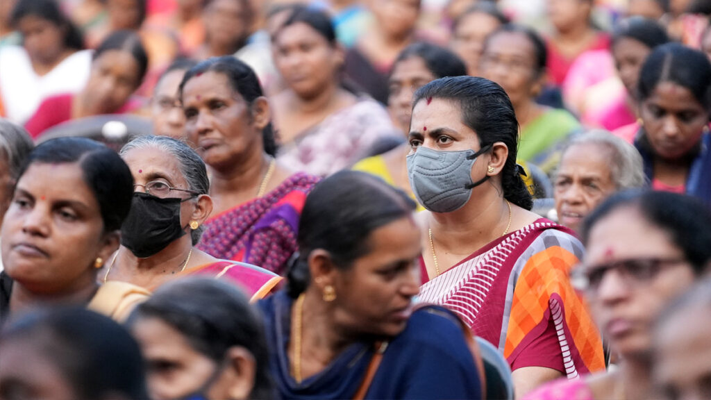 Women in crowd listen