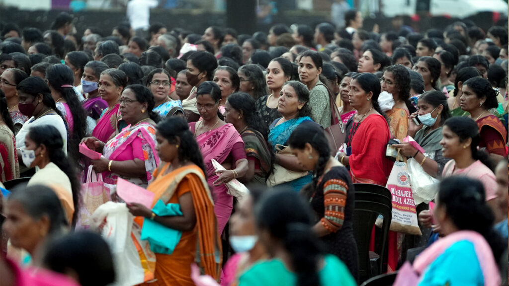 Women wait for aid