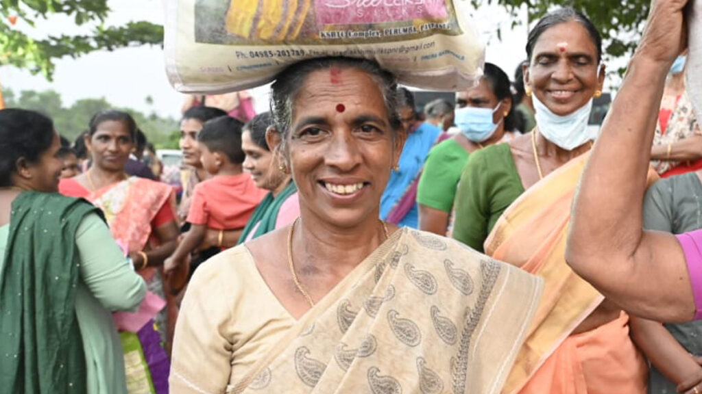 Woman carries her bag of supplies on her head