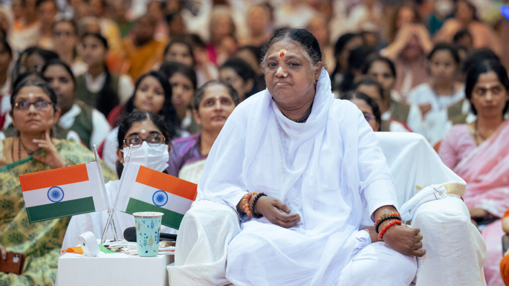 Amma listens intently to other speakers