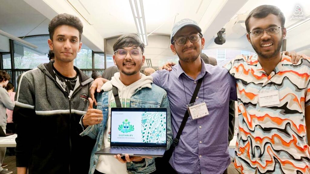 four young men with a laptop