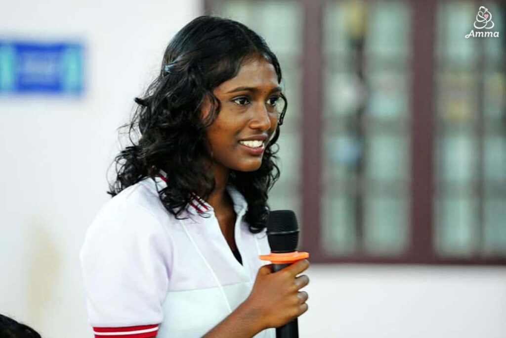 a young woman speaks at a microphone