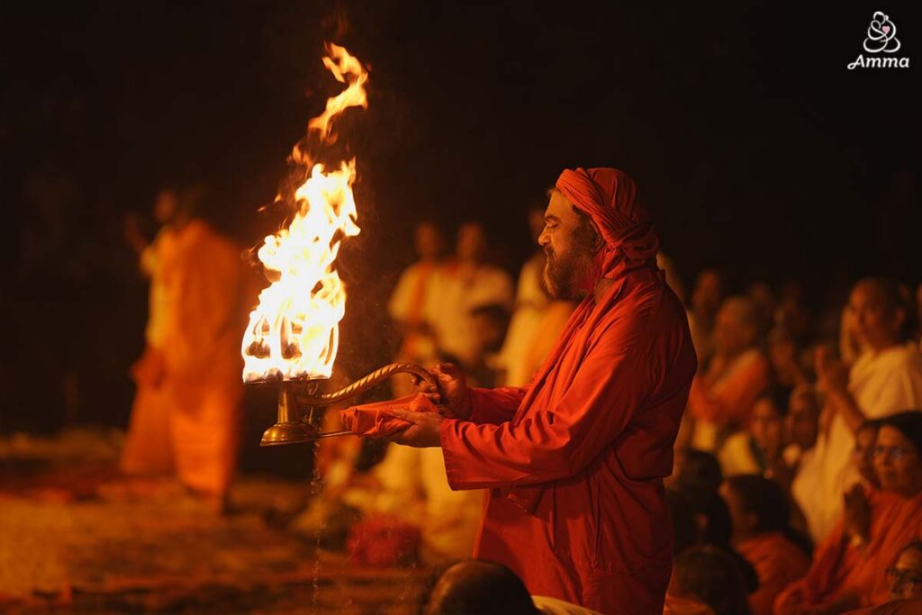 A swami waves the sacred flame