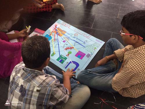 Children play an educational game while seated on the floor