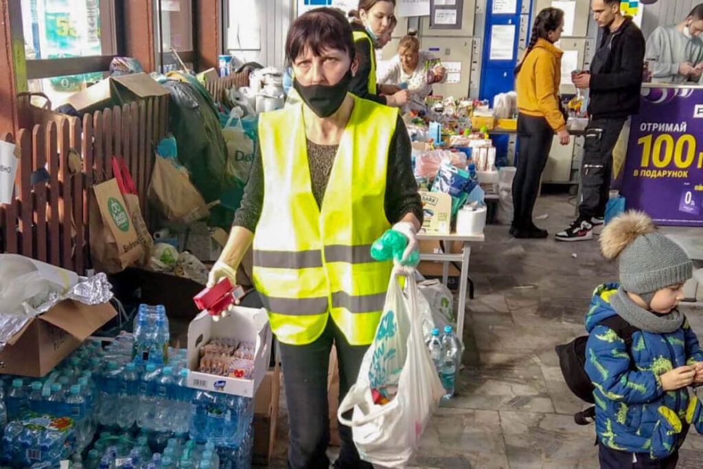 A Polish woman holds a bag of supplies