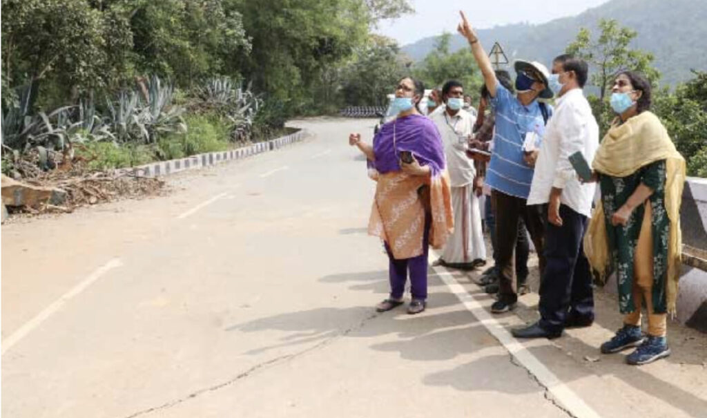 The team stands on the road looking a the the landslides on Thirumala Ghat Road.