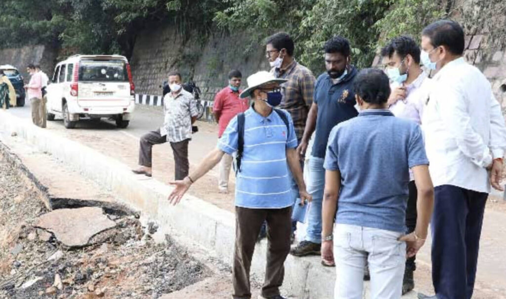 The team pointing to some of the landslide damage along the road.