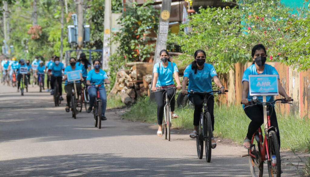 Students cylce in blue shirts