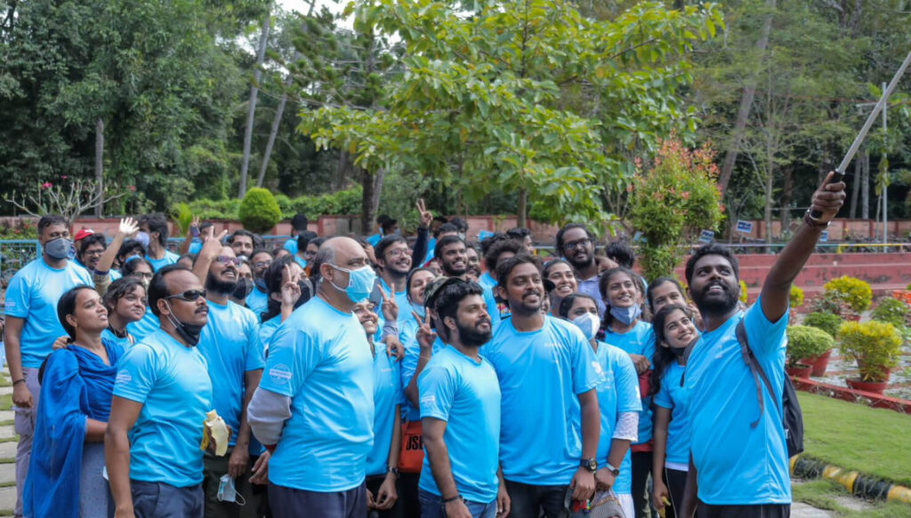 Students stand together in blue shirts