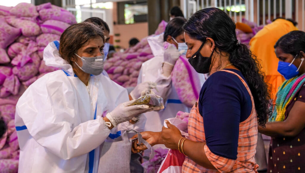 Amritapuri Ashram residents distribute goods