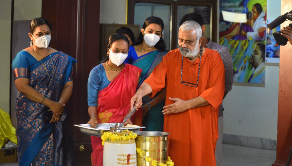 Dean Swami Shankaramritananda Puri, Dean, performs an ancient ritual to celebrate the occasion while others watch