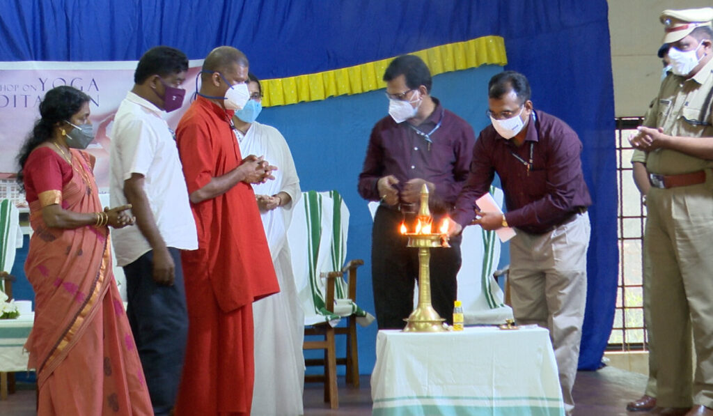 All the prison officials gather on stage around the Arati lamp with Swami Gurupadasthritananda.