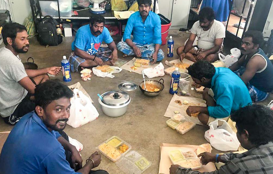 Workers enjoying the meals provided by Amriteswari Society Singapore