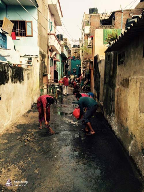 Volunteers try to remove water from the streets using buckets