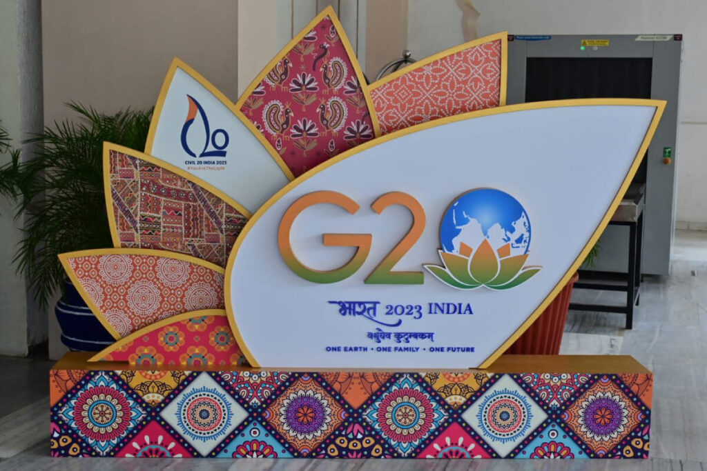 A custom sign designed as a flower showing the G20 logo in the center, with the C20 logo as a petal