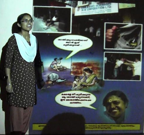 Student speaks in front of poster with cartoons
